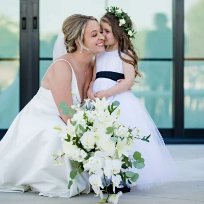 A bride with a flower girl getting married.